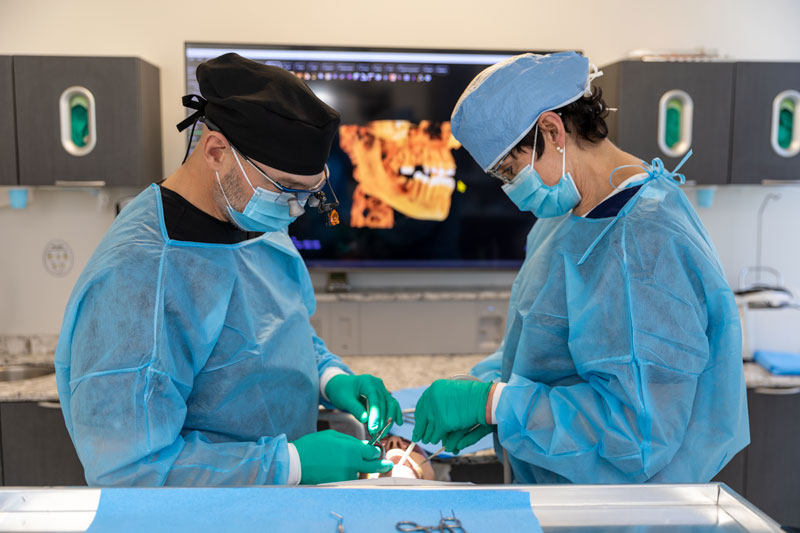 Dentist administering sedation dentistry to a relaxed patient in a modern dental clinic.